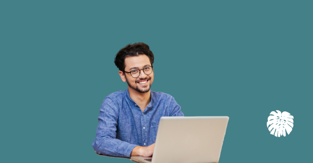 An image of a smiling translation manager sitting in front of a computer and the logo of The Translation Team.